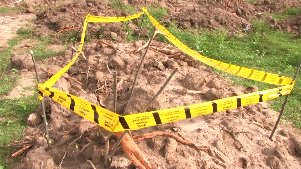  Police tape surrounds a large hole in the ground containing human skeletal remains that were uncovered by coastal erosion in South Wales.